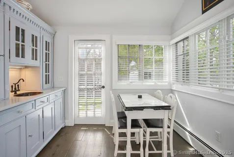 a view of a room with wooden floor and windows