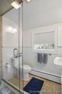 a bathroom with a toilet and a shower