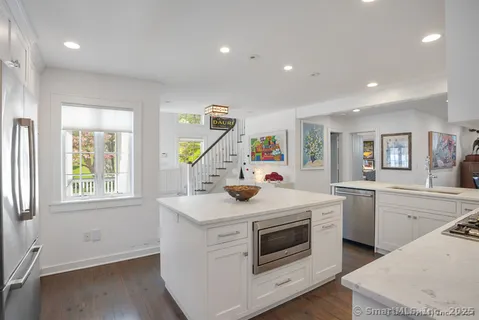 a kitchen that has a sink and a stove in it