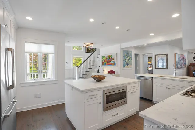 a kitchen that has a sink and a stove in it