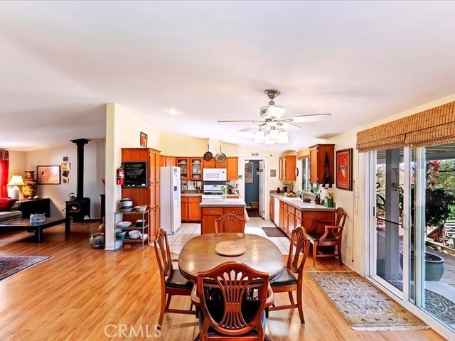 40410 Exa Ely Road Hemet, CA 92544 - Photo 14 of 74 a dining room with furniture a rug a chandelier and wooden floor