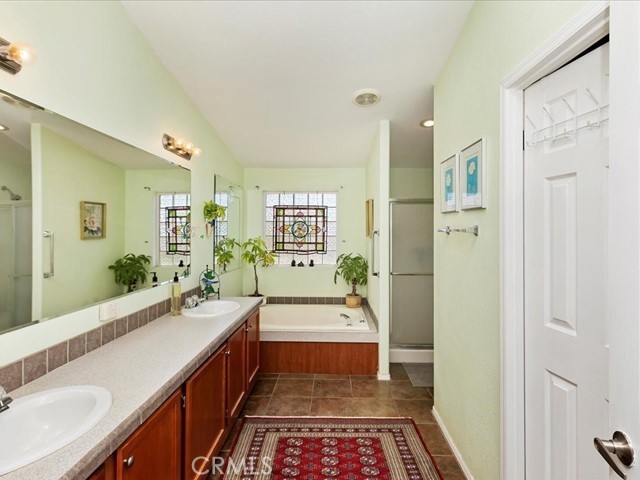 40410 Exa Ely Road Hemet, CA 92544 - Photo 32 of 74 a bathroom with a tub a sink and a large mirror