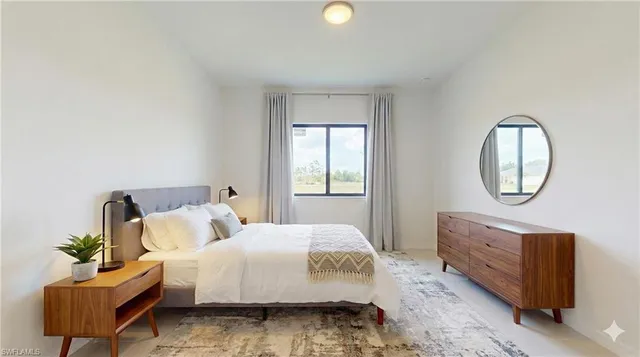 a bedroom with a bed a mirror and a window