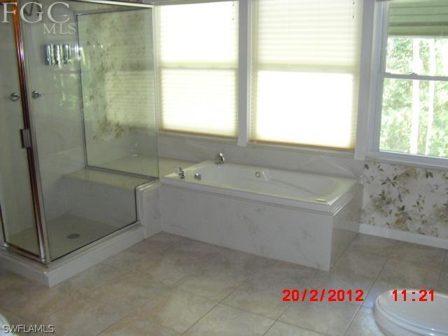 14400 Cemetery Road Fort Myers, FL 33905 - Photo 12 of 17 a bathroom with a bathtub and shower