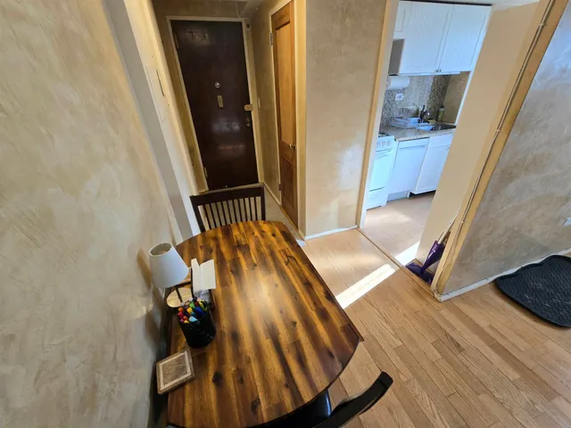 a view of a room with a door and wooden floor