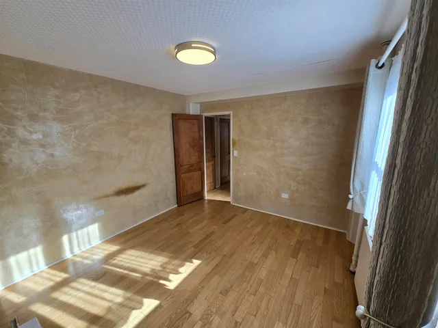 a bathroom with a toilet mirror and vanity