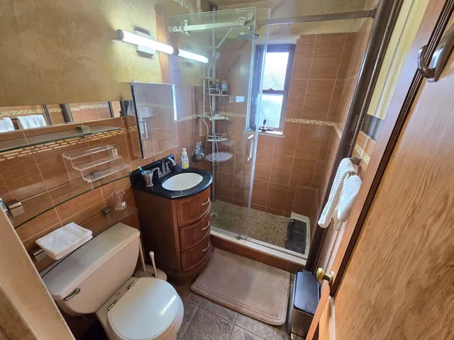 a bathroom with a toilet sink and mirror