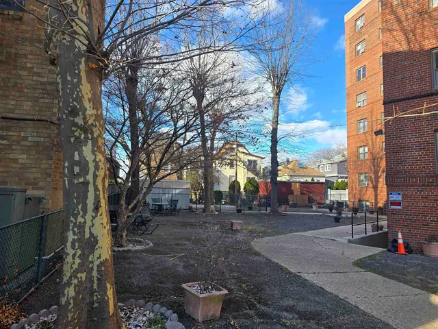 a front view of a house with cars parked