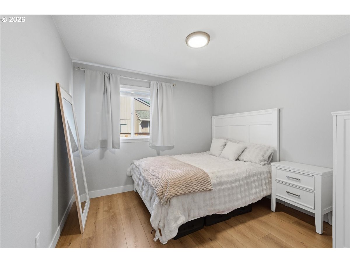 18988 Southwest Pike Lane Beaverton, OR 97078 - Photo 19 of 36 a bedroom with a bed next to a window