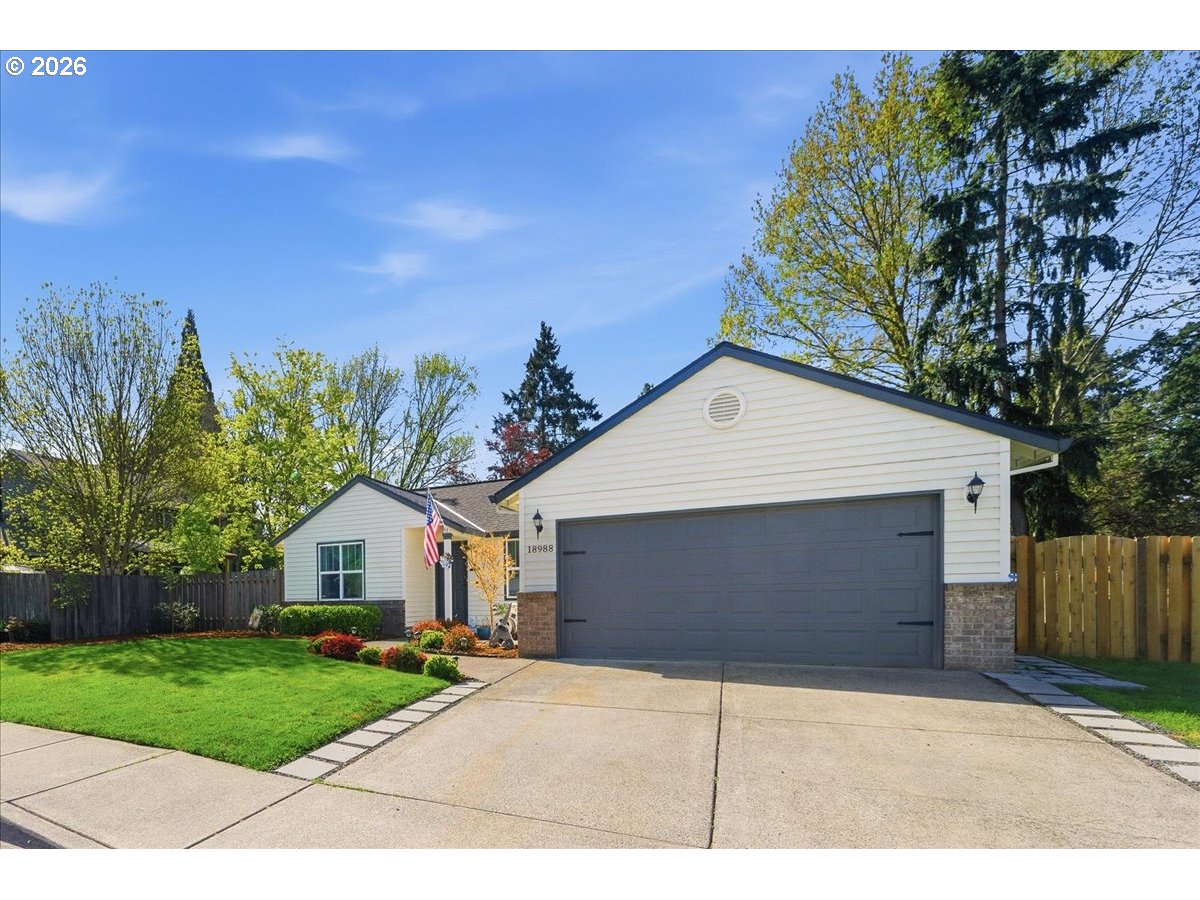 18988 Southwest Pike Lane Beaverton, OR 97078 - Photo 2 of 36 a front view of a house with a yard and garage