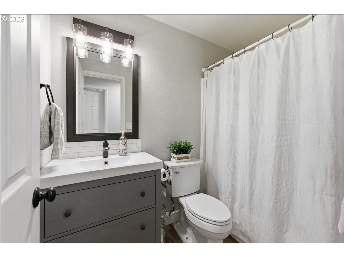 18988 Southwest Pike Lane Beaverton, OR 97078 - Photo 21 of 36 a bathroom with a toilet a sink and a mirror