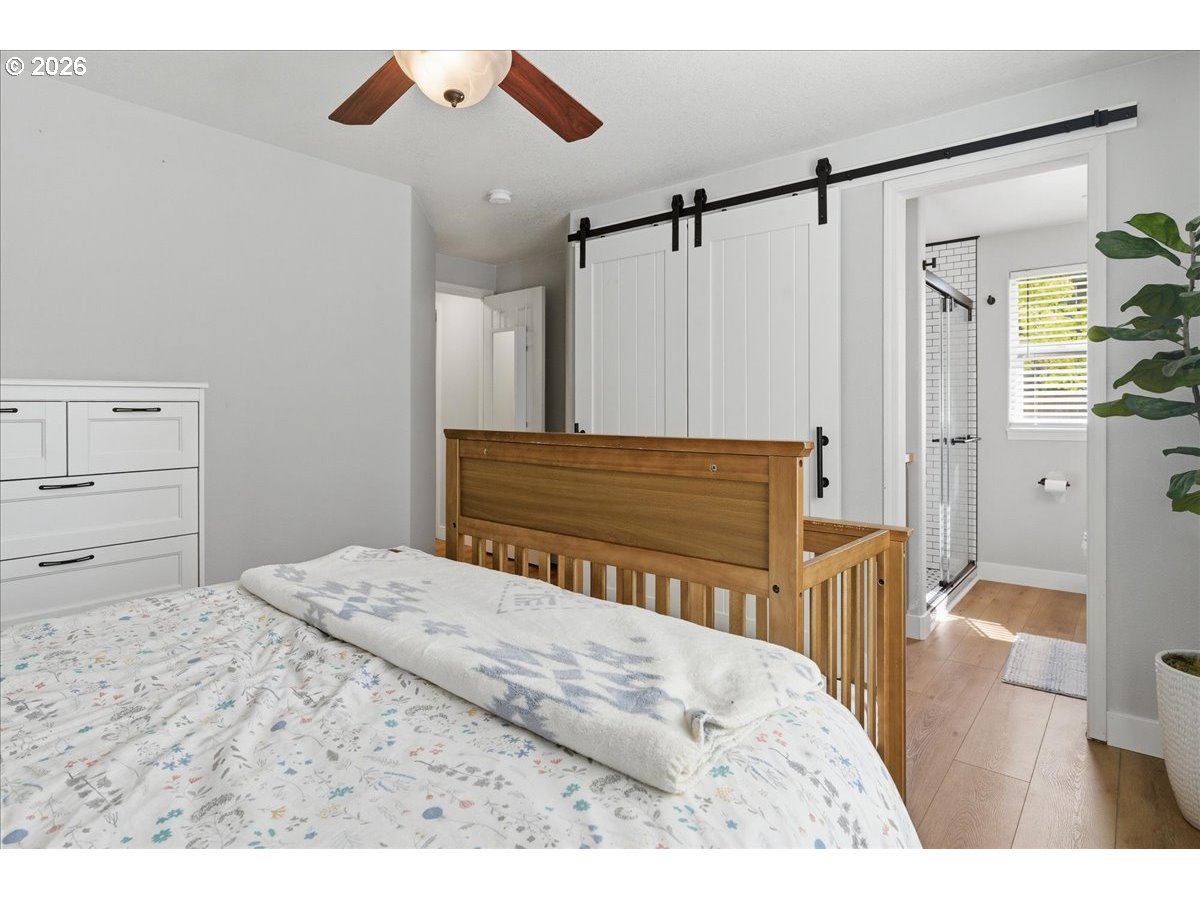 18988 Southwest Pike Lane Beaverton, OR 97078 - Photo 23 of 36 a bedroom with a bed and a dresser