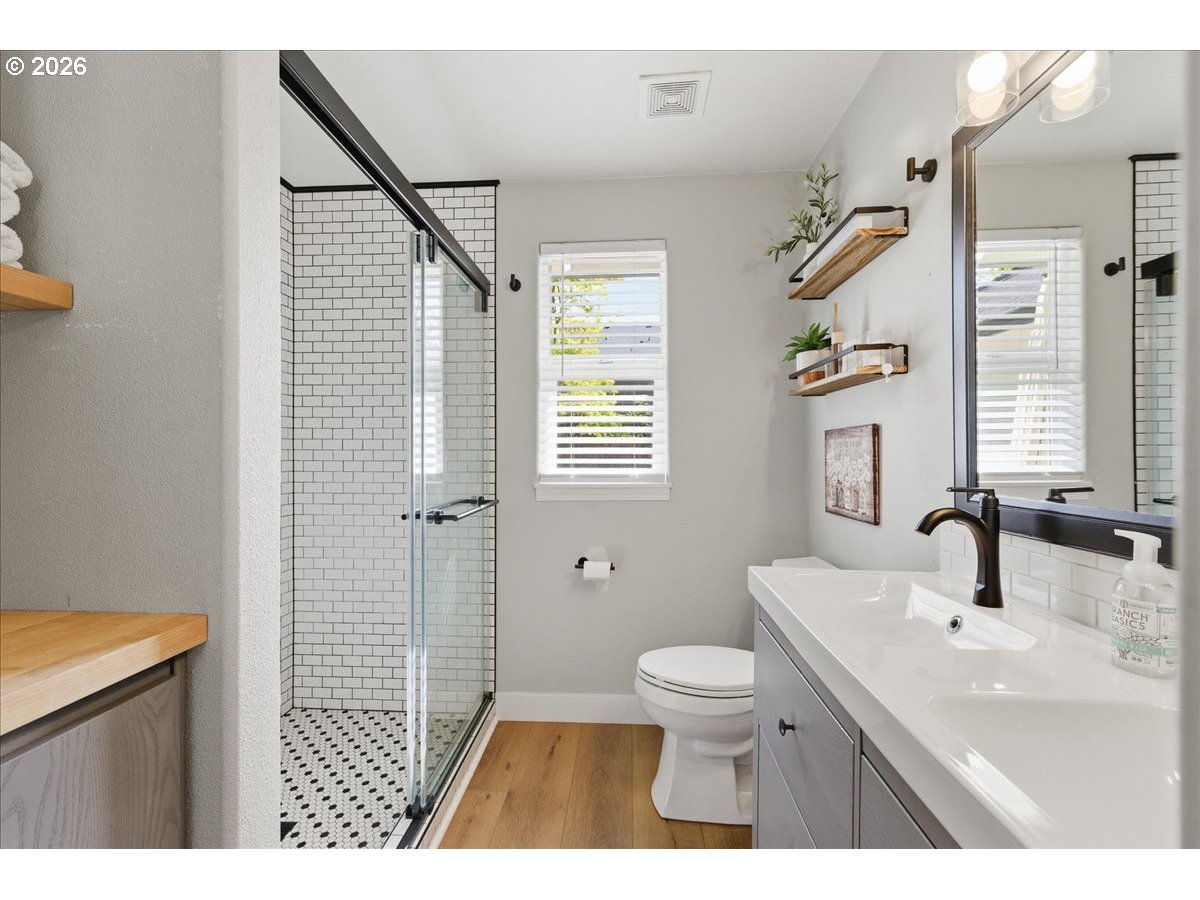 18988 Southwest Pike Lane Beaverton, OR 97078 - Photo 24 of 36 a bathroom with a sink a toilet a mirror and shower