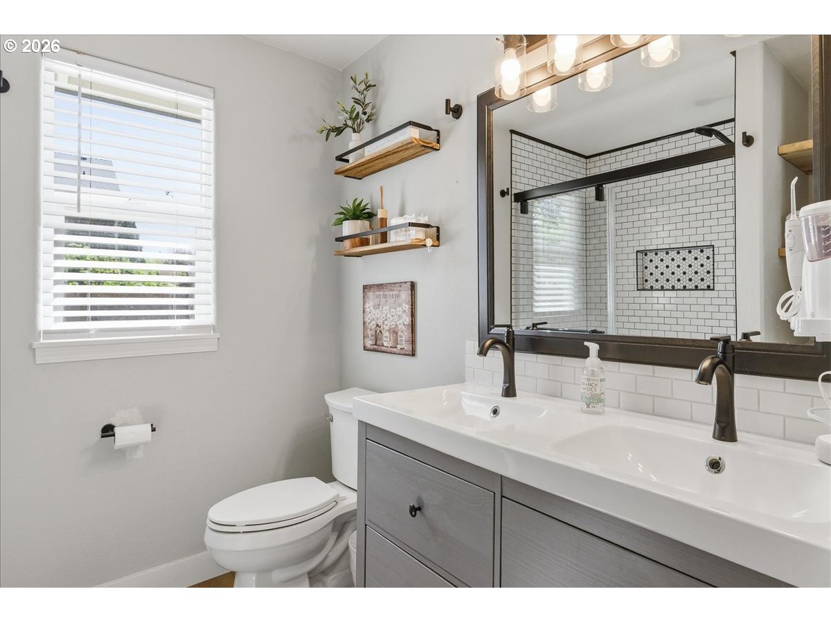 18988 Southwest Pike Lane Beaverton, OR 97078 - Photo 25 of 36 a bathroom with a sink a toilet and mirror