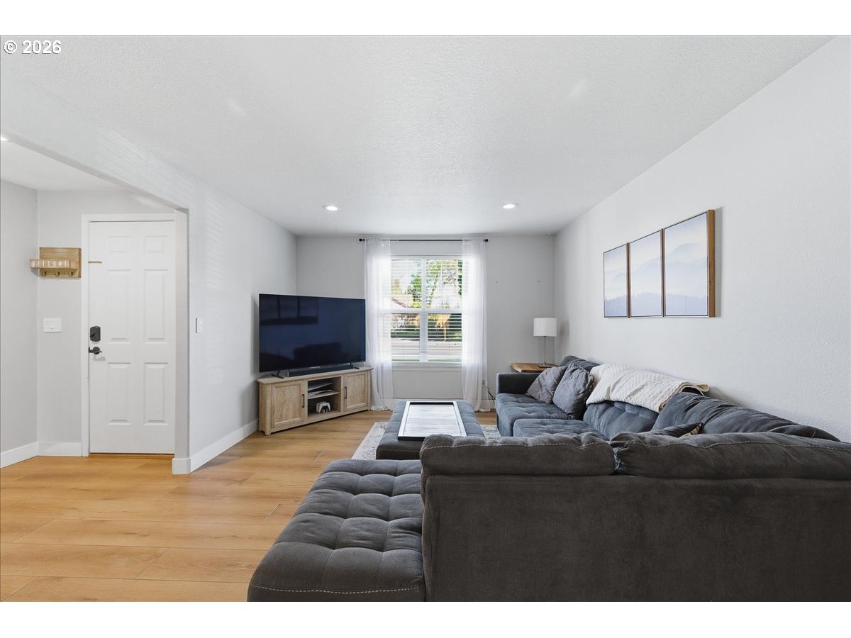18988 Southwest Pike Lane Beaverton, OR 97078 - Photo 5 of 36 a living room with furniture and a flat screen tv