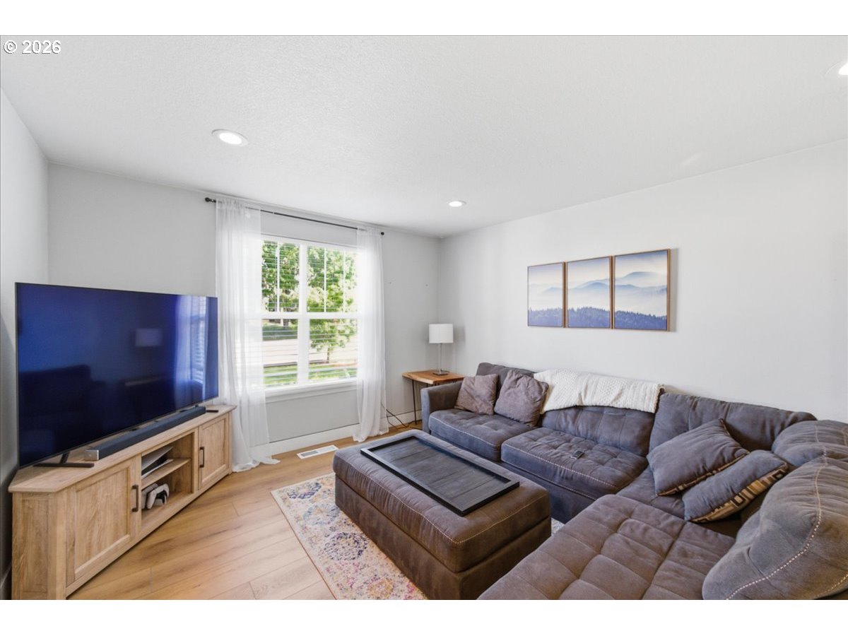 18988 Southwest Pike Lane Beaverton, OR 97078 - Photo 6 of 36 a living room with furniture and a flat screen tv