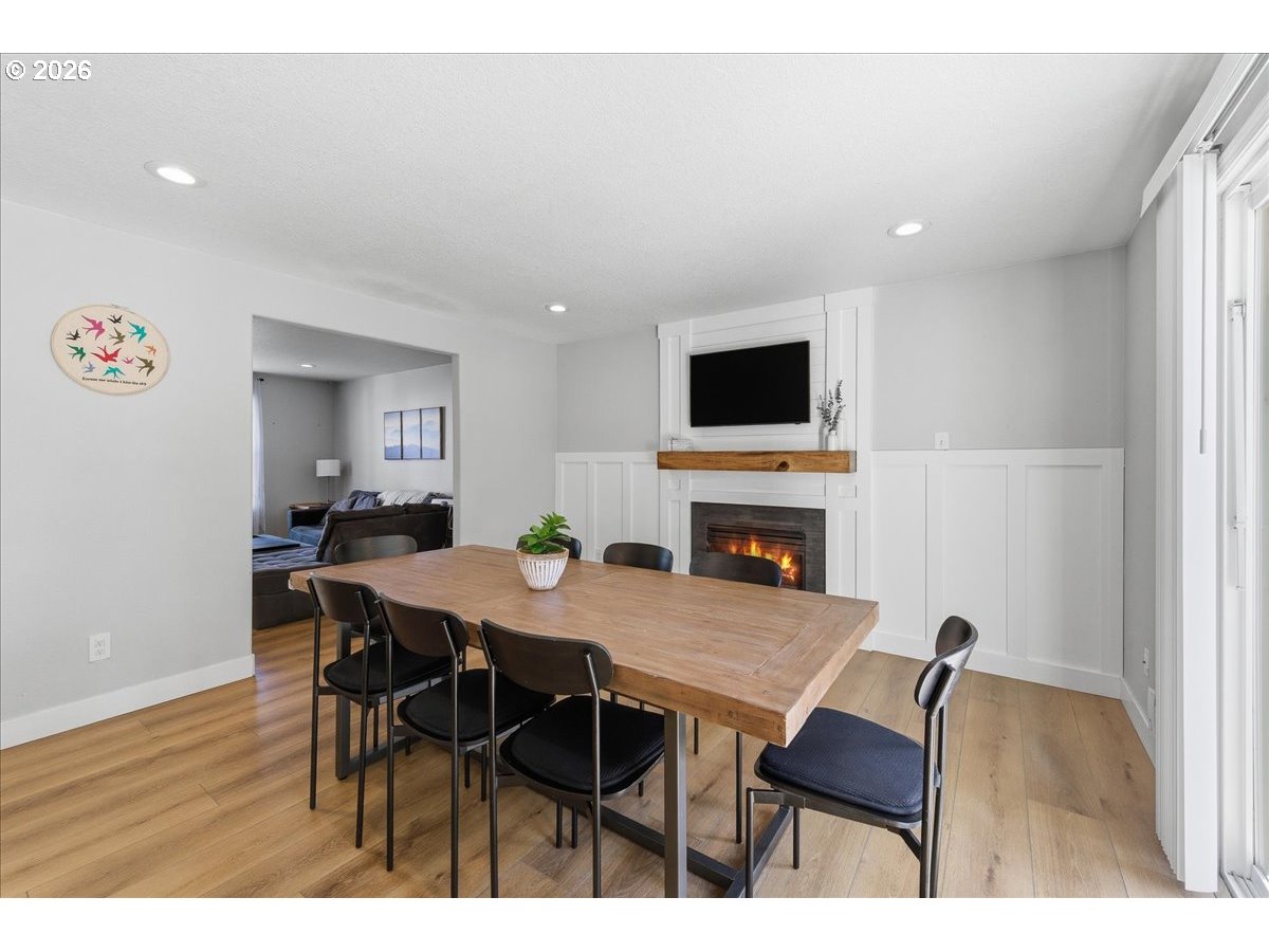 18988 Southwest Pike Lane Beaverton, OR 97078 - Photo 8 of 36 a view of a dining room with furniture and a fireplace