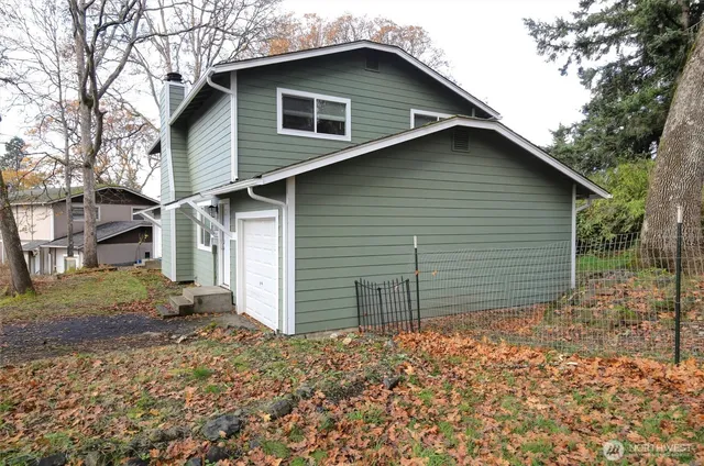 a front view of house with a garden