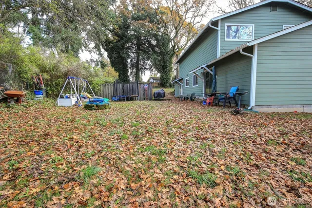 a view of a house with a patio and a yard