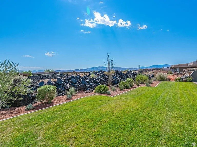 1500 Split Rock, Unit 150 Ivins, UT 84738 - Photo 2 of 18 Lush green lawn with a landscaped planting bed featuring desert-adapted vegetation