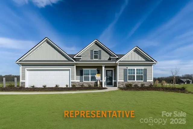 a front view of a house with a garden and yard