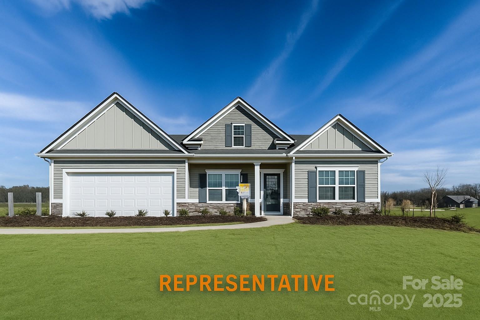 a front view of a house with a garden and yard