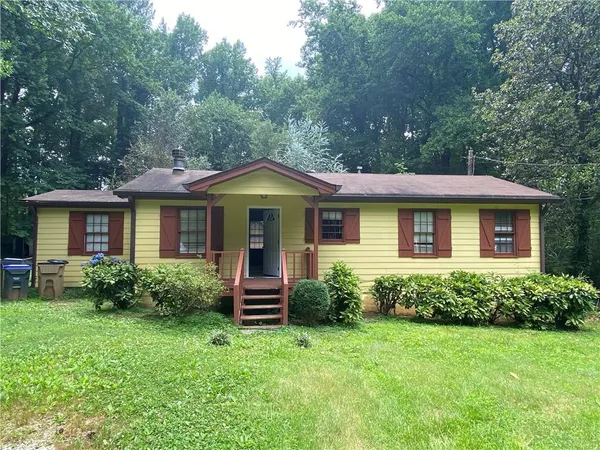 a front view of a house with porch and garden