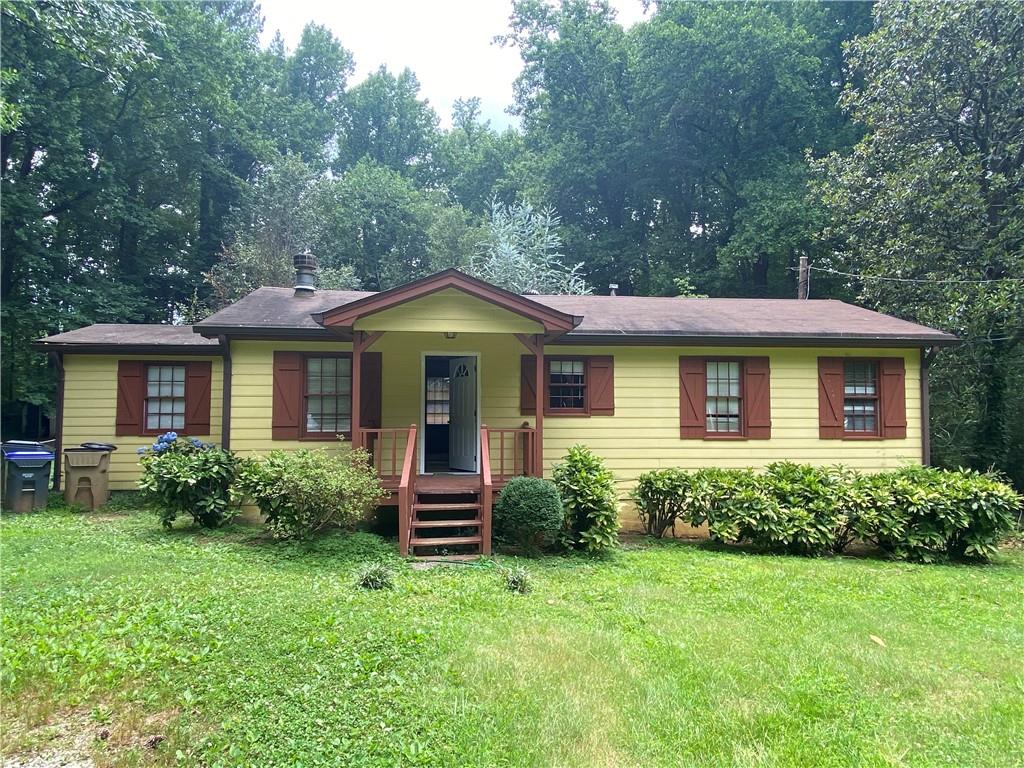 a front view of a house with porch and garden