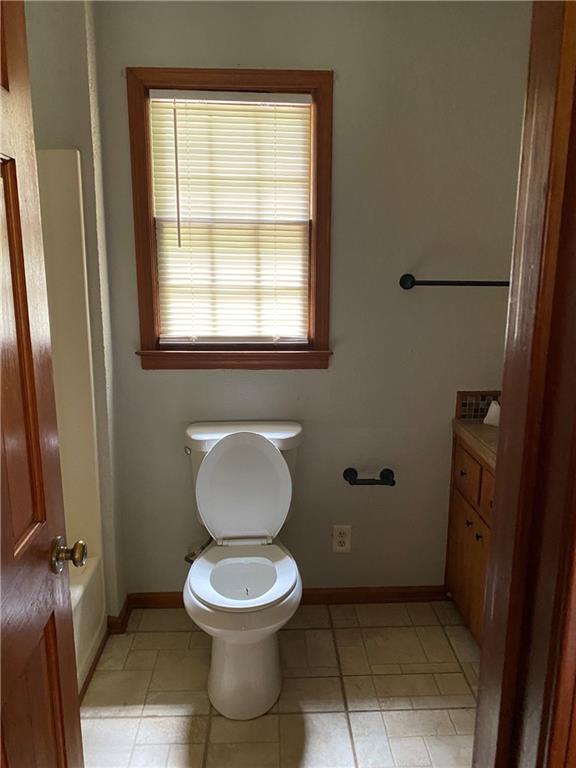207 Hood Road Northwest Lilburn, GA 30047 - Photo 11 of 12 a bathroom with a toilet a sink and a window