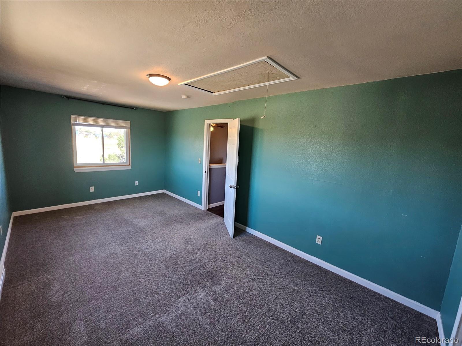 16985 Sage Crest Road Peyton, CO 80831 - Photo 20 of 25 an empty room with windows
