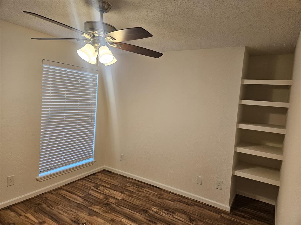 9601 Forest Lane, Unit 224 Dallas, TX 75243 - Photo 15 of 17 wooden floor in an empty room with a window