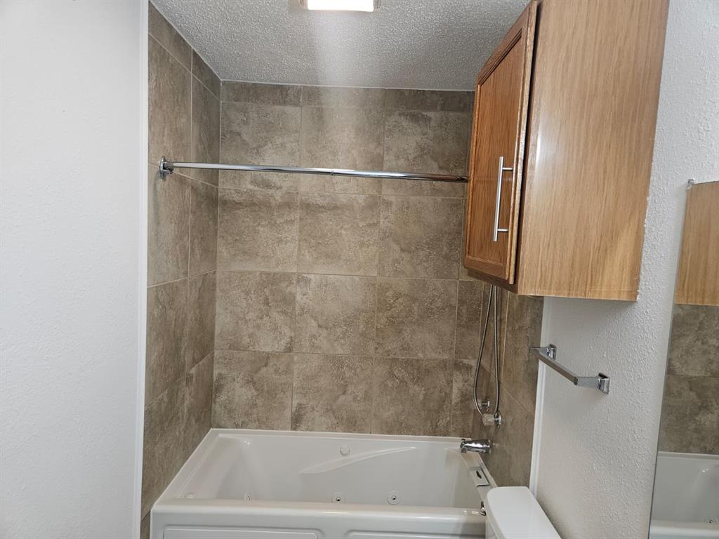 9601 Forest Lane, Unit 224 Dallas, TX 75243 - Photo 16 of 17 a bathroom with a bathtub