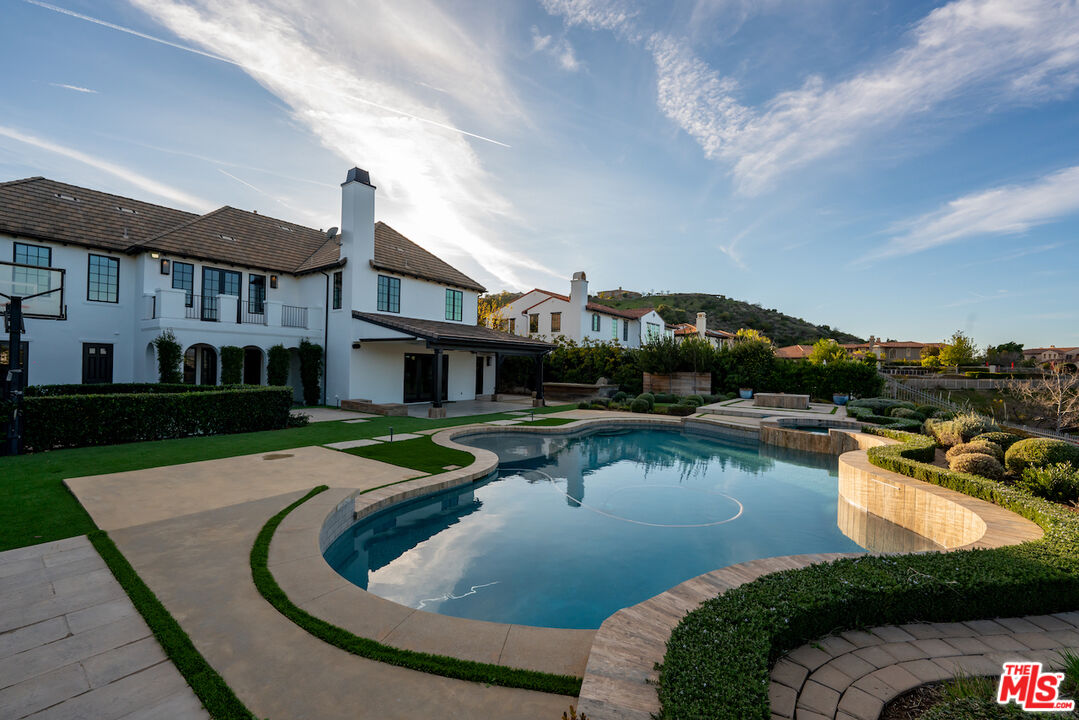 25311 Prado De Ambar Calabasas, CA 91302 - Photo 2 of 58 a view of a house with swimming pool and a yard
