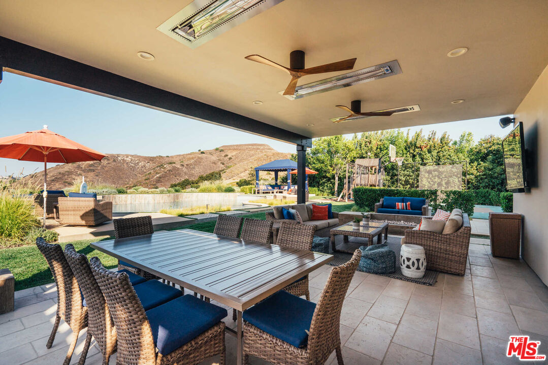 25311 Prado De Ambar Calabasas, CA 91302 - Photo 24 of 58 a view of a patio with a dining table and chairs