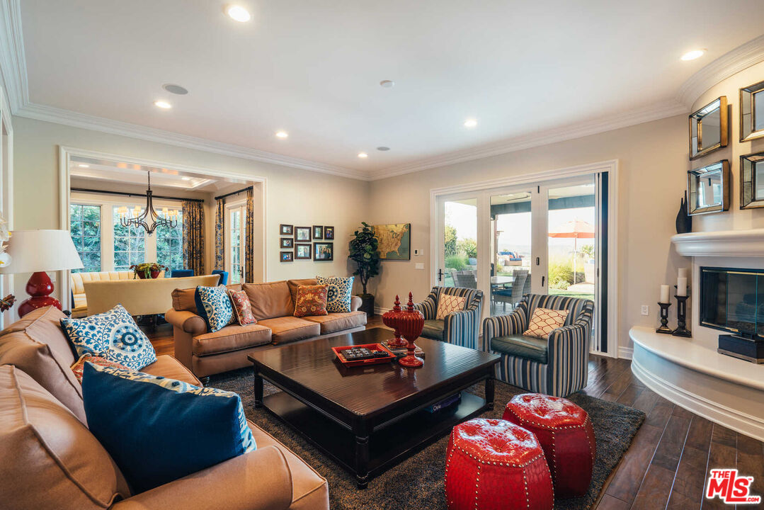 25311 Prado De Ambar Calabasas, CA 91302 - Photo 25 of 58 a living room with furniture fireplace and a large window