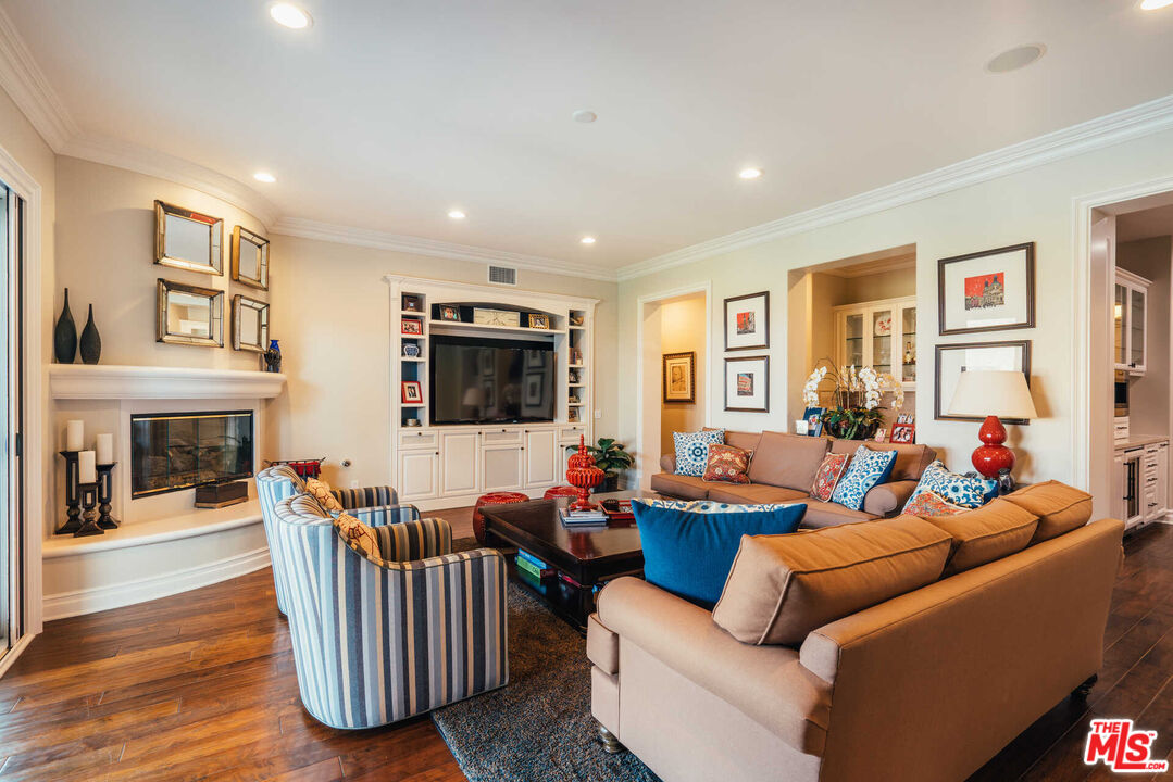 25311 Prado De Ambar Calabasas, CA 91302 - Photo 27 of 58 a living room with furniture a fireplace and a flat screen tv