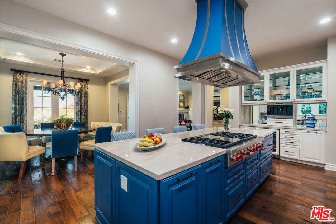 25311 Prado De Ambar Calabasas, CA 91302 - Photo 33 of 58 a kitchen with a stove and a wooden floor