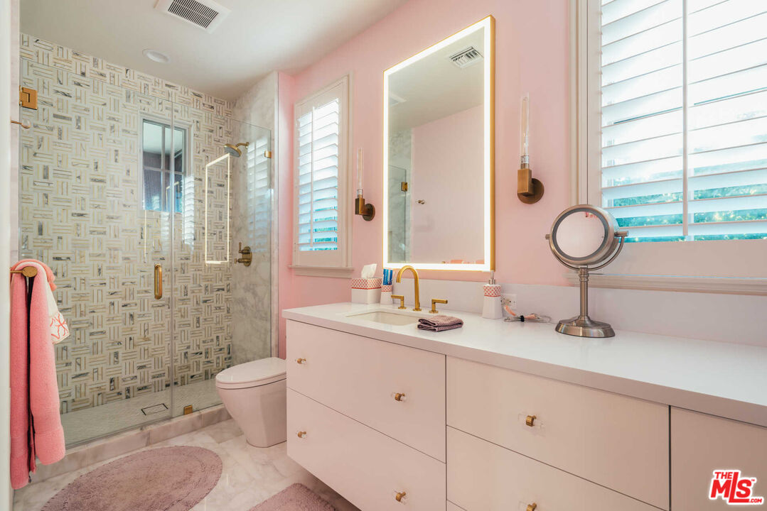 25311 Prado De Ambar Calabasas, CA 91302 - Photo 40 of 58 a bathroom with a granite countertop sink toilet mirror and shower