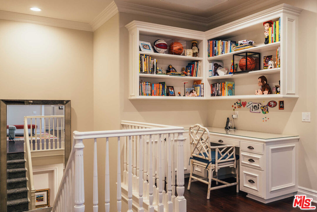 25311 Prado De Ambar Calabasas, CA 91302 - Photo 42 of 58 a bedroom with a bed and a book shelf