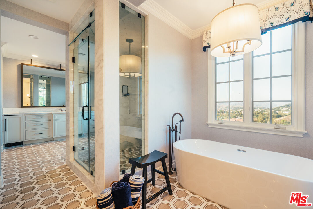 25311 Prado De Ambar Calabasas, CA 91302 - Photo 50 of 58 a bathroom with a tub sink and mirror
