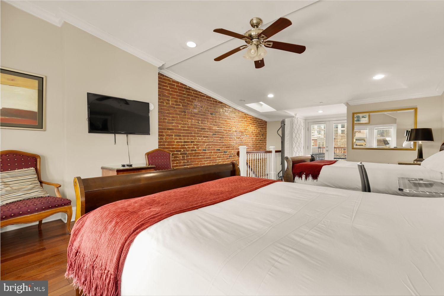 2814 13th Street Northwest Washington, DC 20009 - Photo 13 of 35 a bedroom with a bed and a flat screen tv