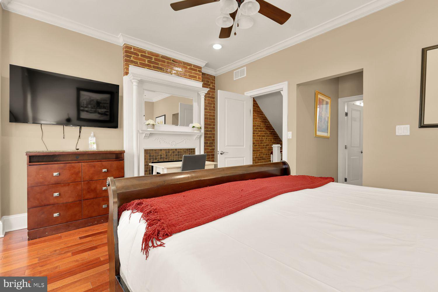 2814 13th Street Northwest Washington, DC 20009 - Photo 21 of 35 a bedroom with a large bed and a flat tv screen on dresser