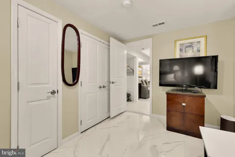 a kitchen with granite countertop a sink cabinets stainless steel appliances and dining table