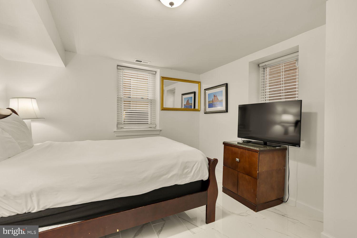 2814 13th Street Northwest Washington, DC 20009 - Photo 34 of 35 a bedroom with a bed and a flat screen tv