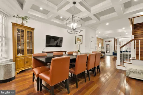 a view of a dining room with furniture wooden floor and chandelier