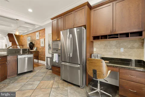 a kitchen with a refrigerator and white cabinets