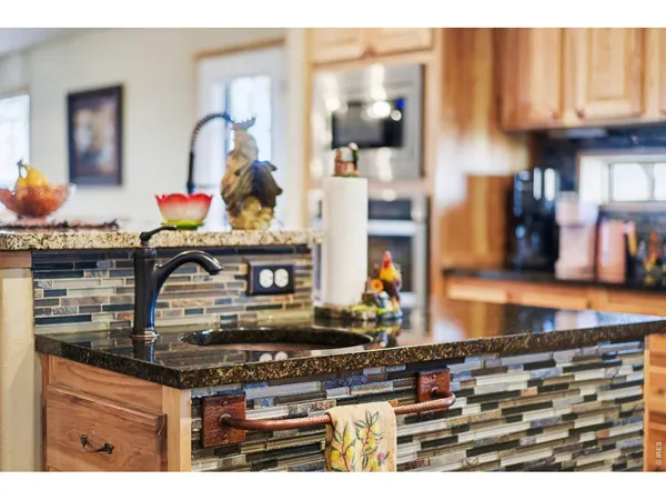 a kitchen with stainless steel appliances granite countertop a stove and cabinets