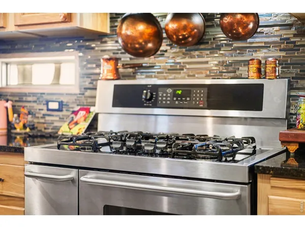 a kitchen with a stove and cabinets