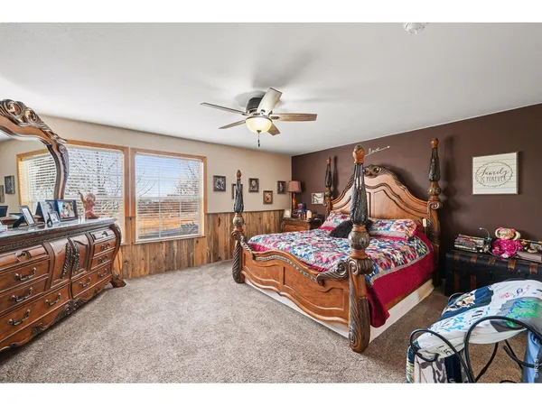 a bedroom with furniture and a large window