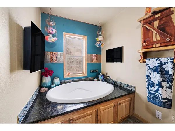 a kitchen with stainless steel appliances granite countertop a stove a sink dishwasher and a refrigerator with wooden floor